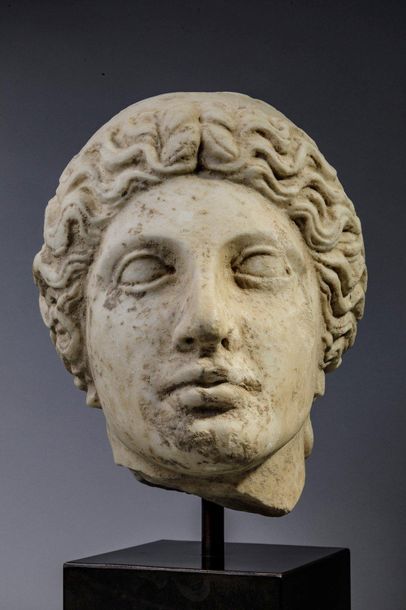 null Female head in marble with hair banded with a headband.
It is colossal in size...