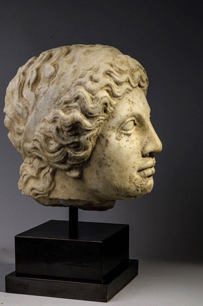 null Female head in marble with hair banded with a headband.
It is colossal in size...