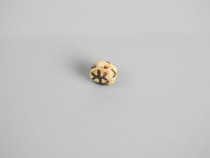 null Bead decorated with a geometrical pattern.glass paste.
First millennia.L :1...