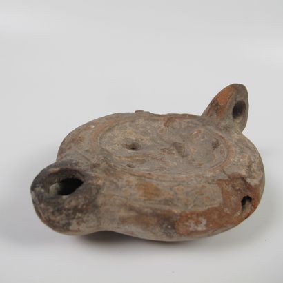 null Oil lamp with relief decoration of Diana with the bow. Terracotta. L 11cm. As...