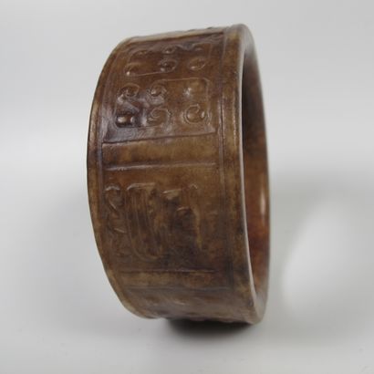 null Jade bracelet decorated with germinating grains and ideograms in relief. Nephrite....