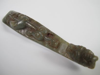 null Celadon jade fibula. Nephrite. L 12cm. Finely carved with a Chilong in a round...
