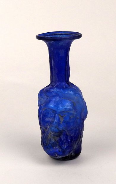 null Anthropomorphic bottle representing a bearded man

Coloured glass 14 cm

Roman...