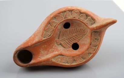 null So-called Christian oil lamp with a vertical ear or palm decoration in a floral...