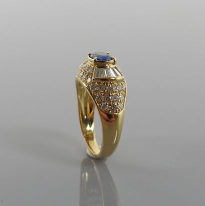 null Beautiful Dome ring in yellow gold, 750 MM, centered of an oval sapphire shouldered...