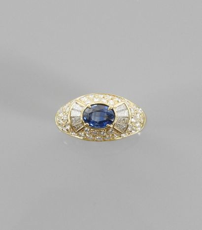 null Beautiful Dome ring in yellow gold, 750 MM, centered of an oval sapphire shouldered...