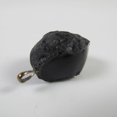 null Tectite called tear of the earth mounted in pendant. Impactite (silicates)....