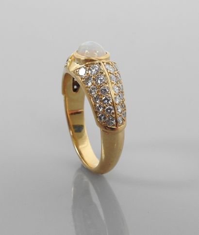 null Yellow gold ring, 750 MM, centered on a cabochon opal between two diamond pavings,...