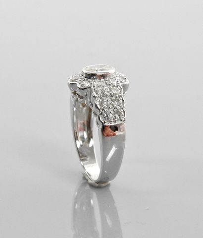 null Ring drawing a white gold floret, centered with an oval diamond weighing about...