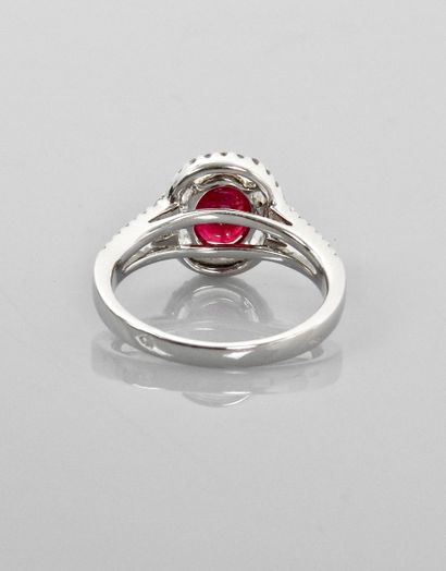 null White gold ring, 750 MM, centered on an oval ruby weighing 2.01 carat hemmed...