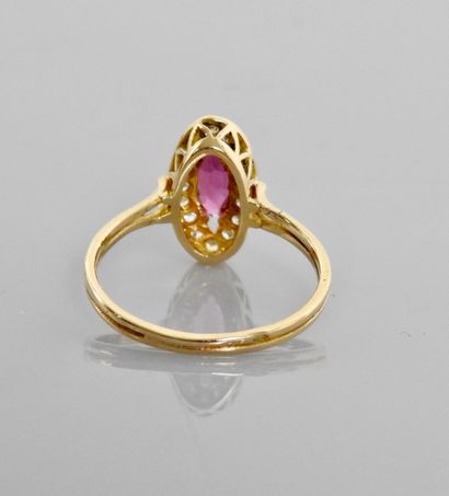 null Yellow gold ring, 750 MM, centered on a navette-cut ruby surrounded by diamonds,...