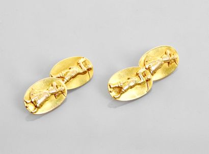 null 
Pair of yellow gold oval pattern cufflinks, 585 MM, each depicting a golfer...