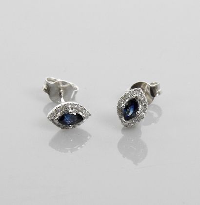 null Earrings in white gold, 750 MM, each set with a navette-cut sapphire hemmed...