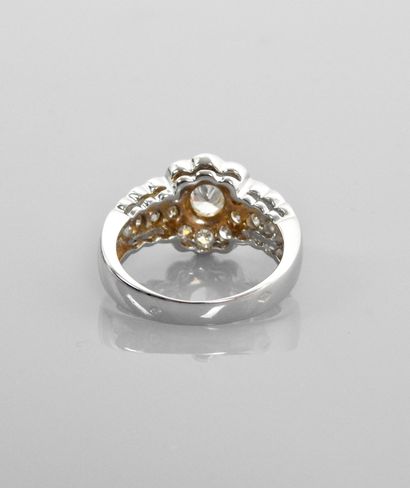 null Ring drawing a white gold floret, centered with an oval diamond weighing about...