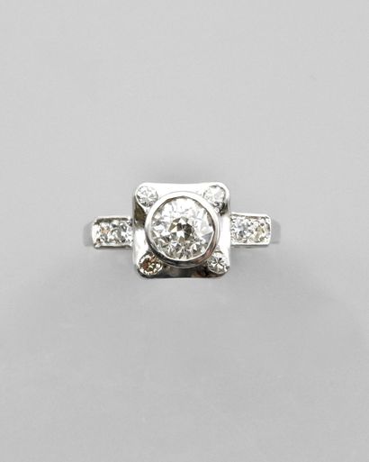 null A 900 mm platinum ring, centered on a diamond weighing approximately 1 carat,...