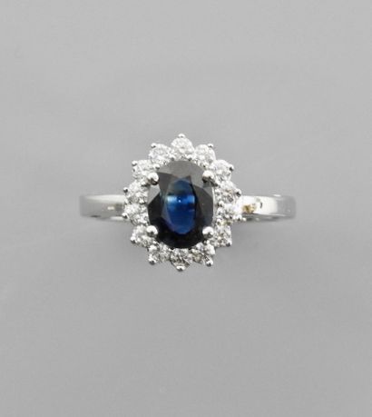 null White gold ring, 750 MM, set with an oval sapphire weighing about 1.40 carat,...