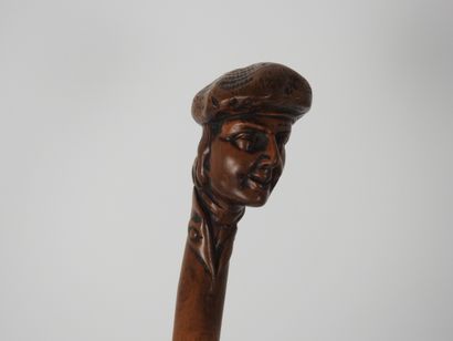 null Cane in one piece, the knob carved with a young man's head wearing a beret

Folk...