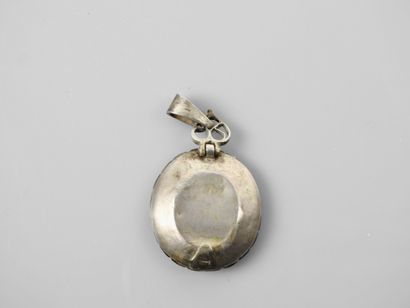 null Talismanic pendant decorated with a magic formula

Propitiatory, silver setting...