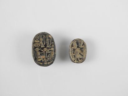 null Two inscribed scacrabs, black stone, 2 to 3 cm long, New Kingdom or later.