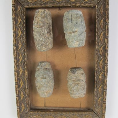 null Set of four small schematic anthropomorphic idols. Grey-green speckled hard...