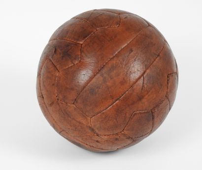 null Football. Old dark brown leather football (18 sides cut out in groups of 3),...