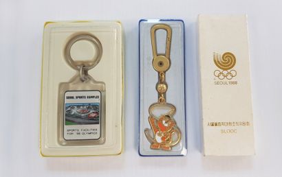 Olympic Games. Two key rings in their cases;...