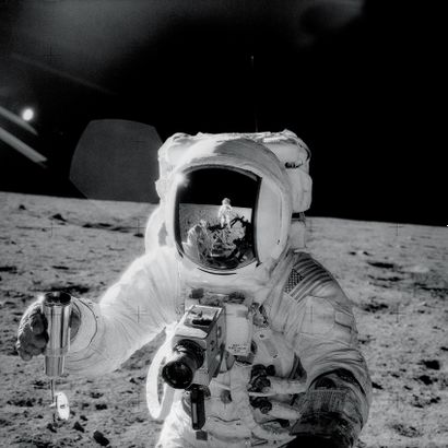 null Nasa. Astronaut Alan Bean on the Moon, holding a special container of soil samples...