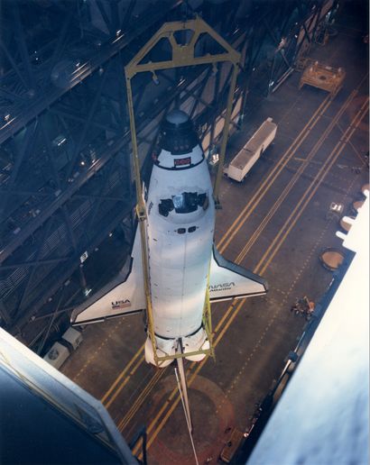 null NASA. Space Shuttle Atlantis is placed on its external tank with a lifting crane...