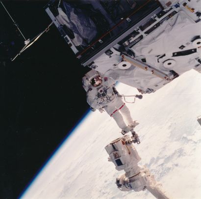 null Nasa. Astronaut Jerry L. Ross floating in the vacuum of space, hanging by his...