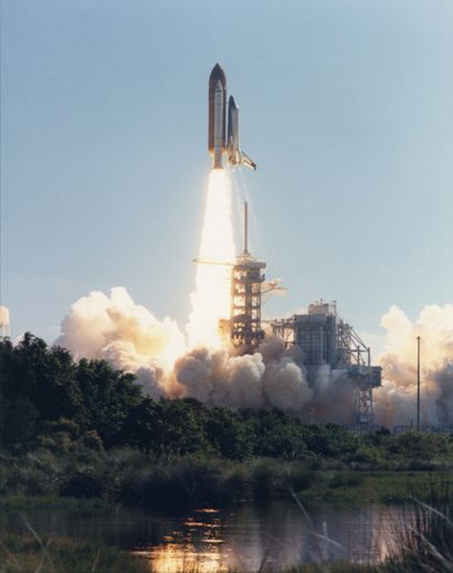 null NASA. The space shuttle Columbia rises like a golden tower in the royal blue...