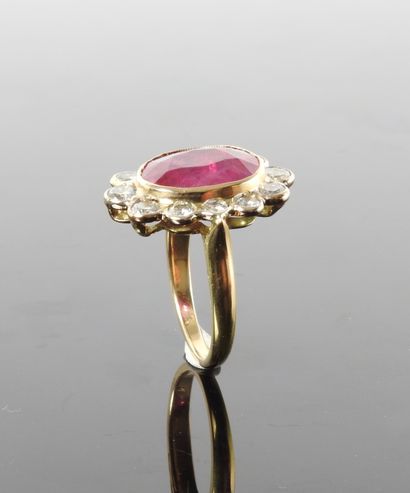 null 
Flat ring in white and yellow gold, 750 MM, centered on an oval ruby weighing...