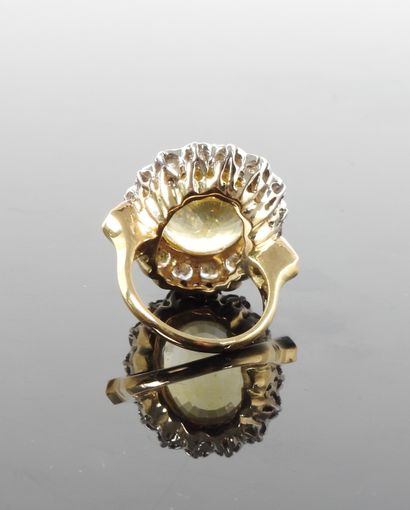 null 
Ring in white and yellow gold, 750 MM, centered on an oval yellow sapphire...