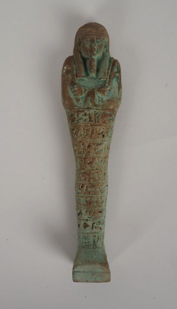 null Fine oushebti in frit or glass paste inscribed with lines of hieroglyphs.
665-332...