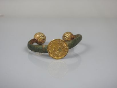 null Bronze bracelet decorated with a gold coin from the late Roman Empire, ending...