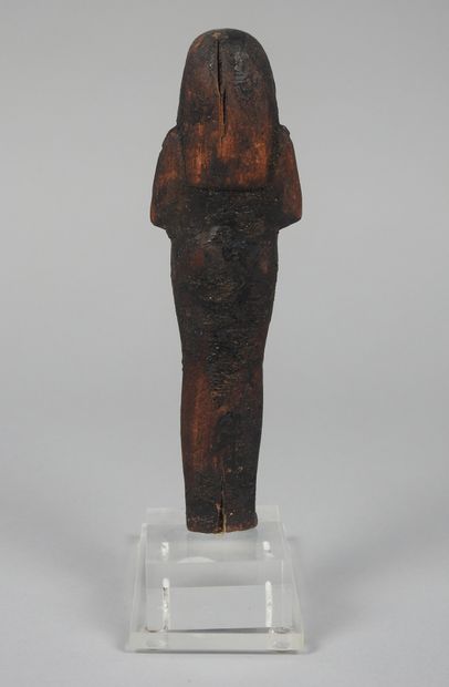 null Chaouabti in the guise of Seti I. Carved wood. New Empire style.
H :14cm.