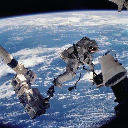 NASA NASA. LARGE FORMAT. Impressive photograph showing astronaut David A. Wolf anchored...