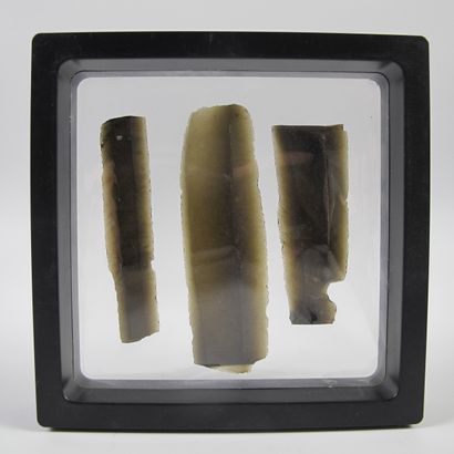 null Three obsidian blades, sickle elements. L 5.5 to 7.5cm. Presented on a 3D frame...