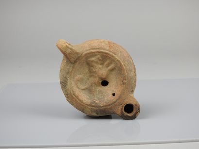 null Oil lamp with round spout decorated with a playing dog

Old Bigot collection

Terracotta...