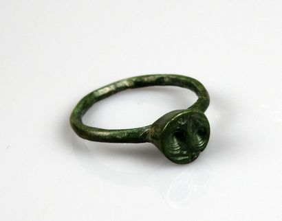 null Ring with hollowed-out decoration of caprids in scrolls symbolizing the body

Bronze...