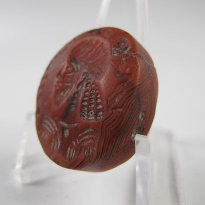 null Intaglio showing a bearded figure surrounded by an inscription in the Persian...