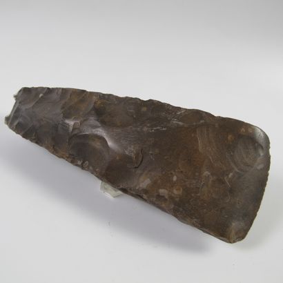 null Polished axe with rectangular section partially cut on the edges. Dark brown...