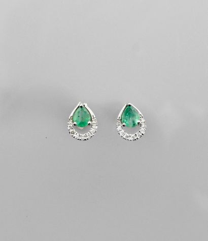 null Earrings in white gold, 750 MM, each set with a pear-cut emerald, edged with...