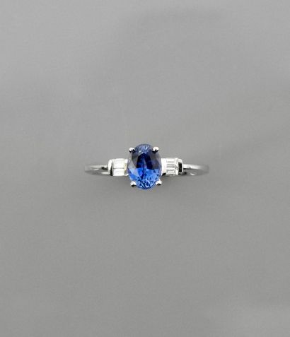 null White gold ring, 750 MM, set with an oval sapphire weighing 1.15 carats, with...