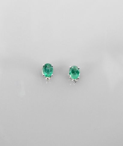null Earrings in white gold, 750 MM, each with a diamond above an oval emerald, total...