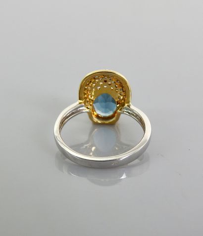 null Ring in silver 925 MM, decorated with a blue topaz oval against a pavement of...