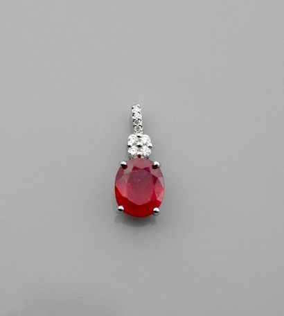 null A white gold pendant with an oval ruby weighing 5 carats crowned with eight...