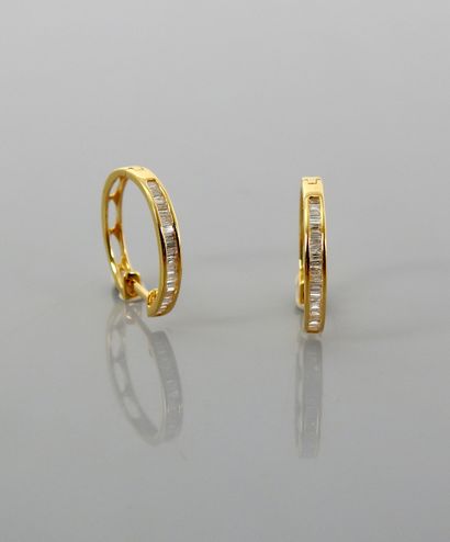 null Yellow gold hoop earrings, 750 MM, highlighted with baguette-cut diamonds, weight:...