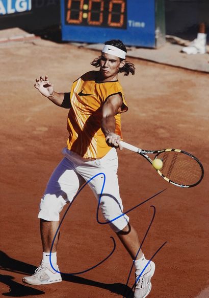 null Tennis / Nadal / Autograph. On beautiful color photo of Rafa in action at Roland,...