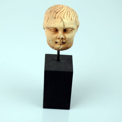 null Head of a young man.


 Roman style.marble.collage at the back.H :7cm.