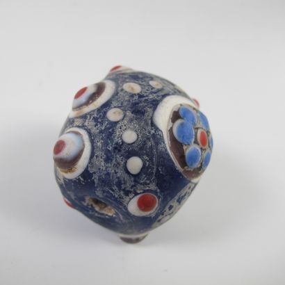 null Asia. China. Large mamelonned bead in a barrel with 6 symbolic ocelli. Glass...